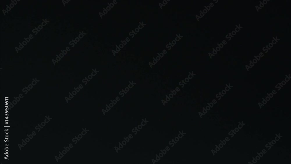 Man opens a bottle of mineral sparkling water on a black background Man opens a bottle of mineral sparkling water on a black background
