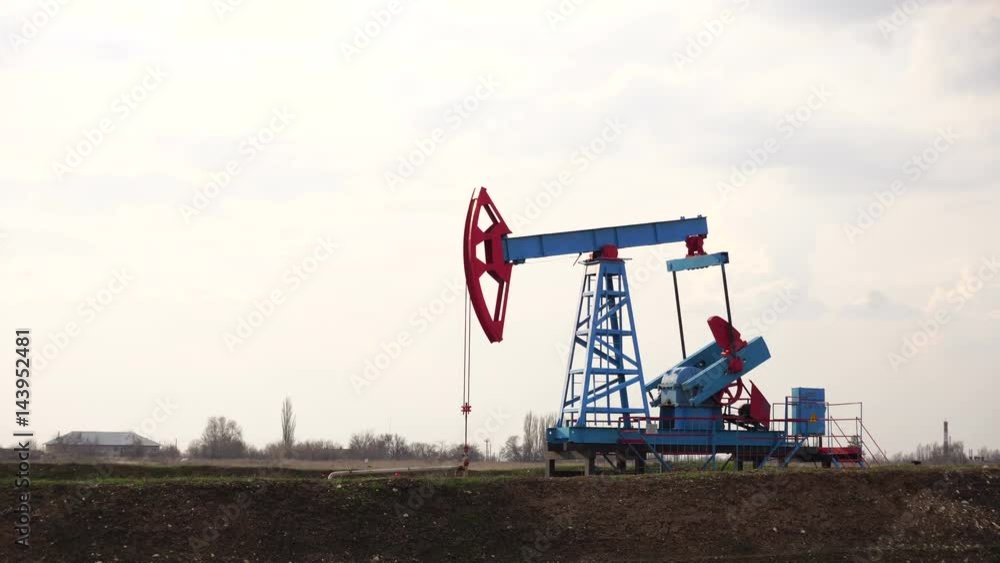 Oil pump in the field. Gloomy stormy sky. Oil pump in the field. Gloomy stormy sky.