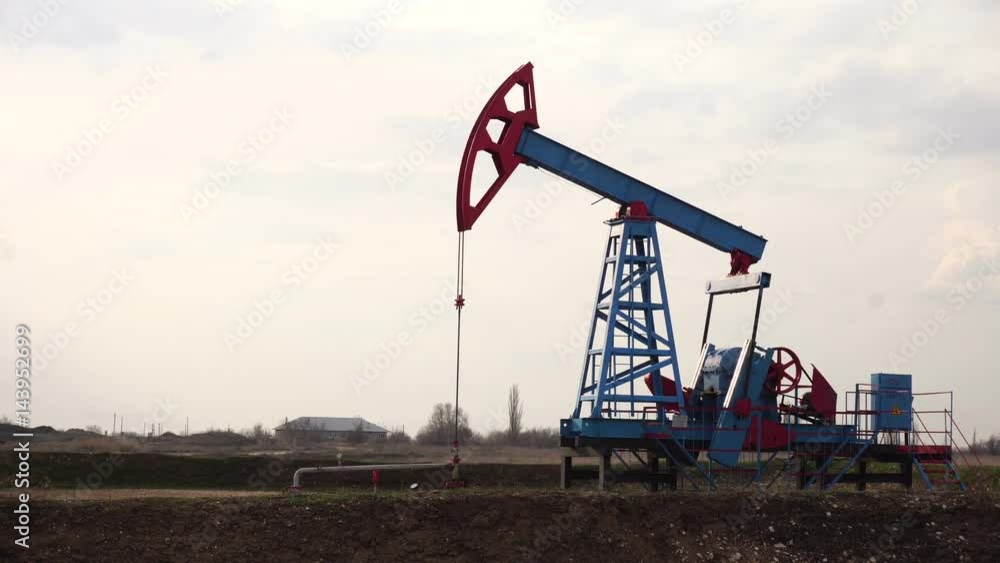 Oil pump in the field. Gloomy stormy sky. Oil pump in the field. Gloomy stormy sky.