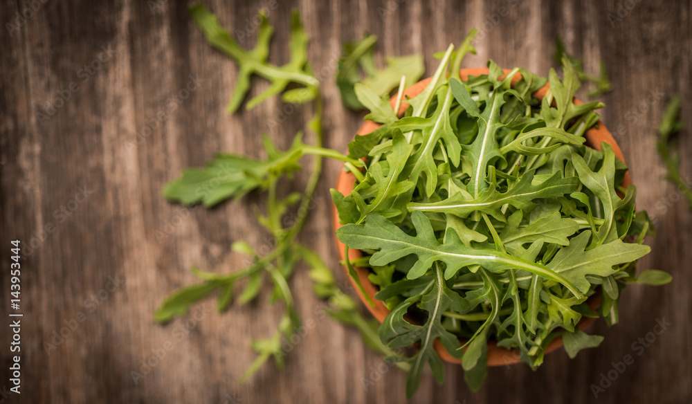 Fresh juicy arugula on wooden background and copy space Fresh juicy arugula on wooden background and copy space