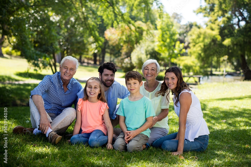Multi generation family sitting in park Multi generation family sitting in park