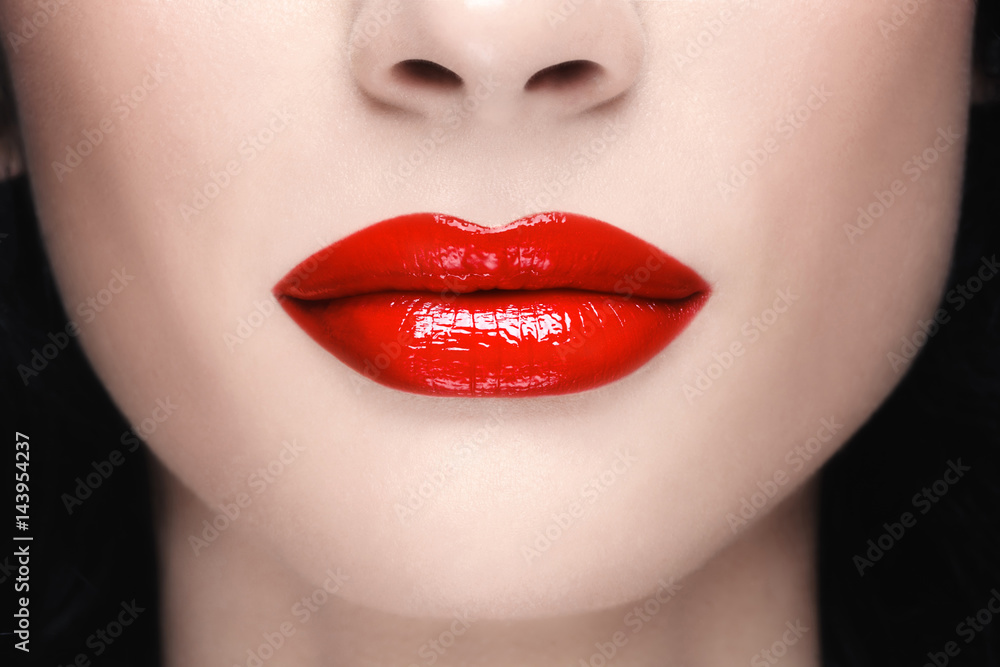 Close-up shot of woman's lips with glossy red lipstick Close-up shot of woman's lips with glossy red lipstick
