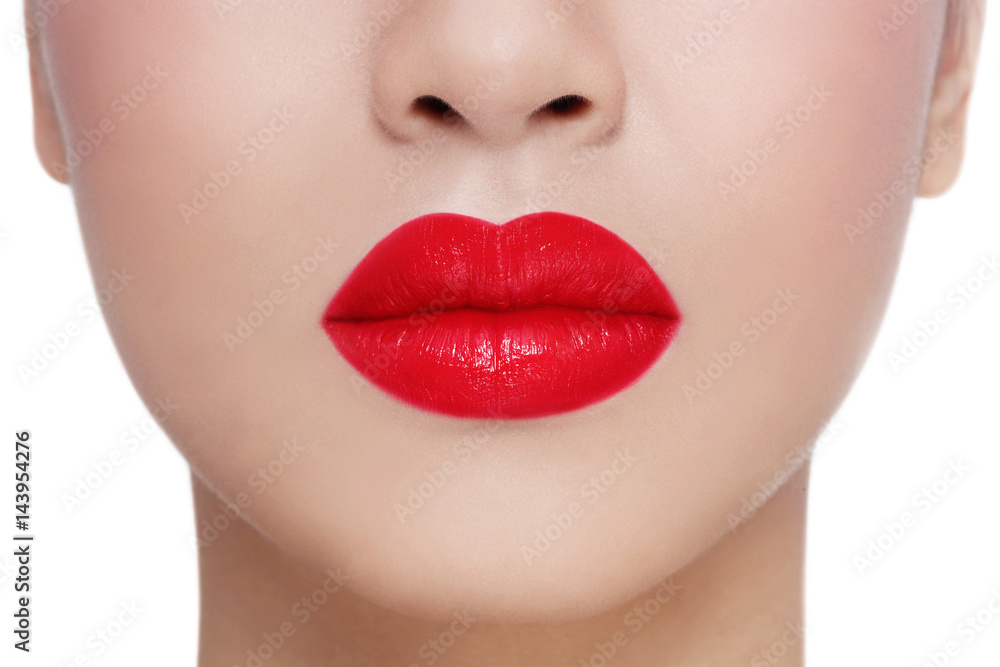 Fototapeta premium Close-up shot of beautiful woman lips over white background