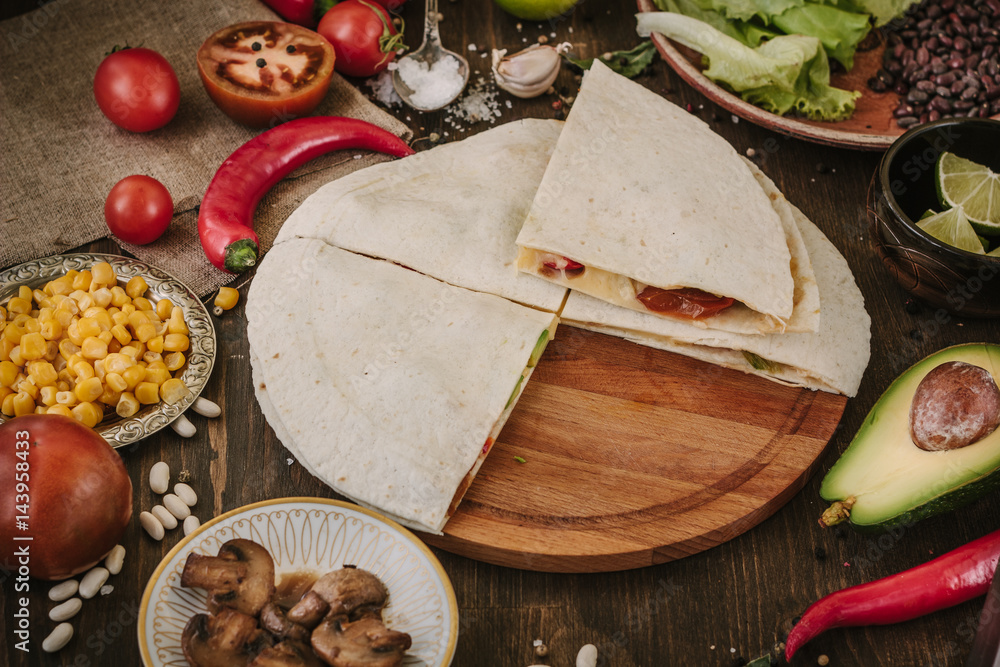 Nice vegetarian quesadilla with tortilla bread, beans, cheese and vegetables. Nice vegetarian quesadilla with tortilla bread, beans, cheese and vegetables.