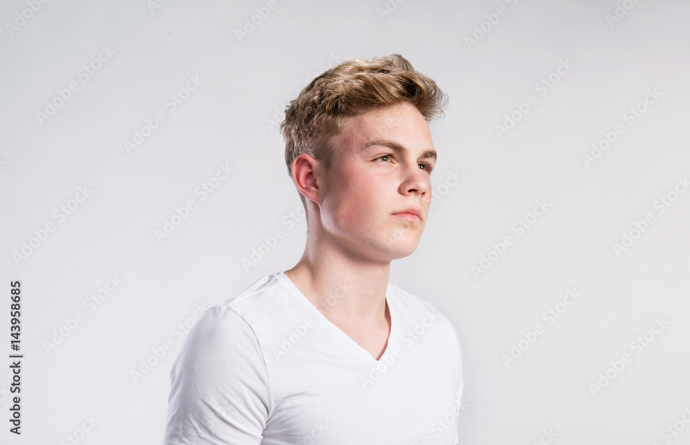 Young handsome hipster man in white t-shirt, studio shot. Young handsome hipster man in white t-shirt, studio shot.