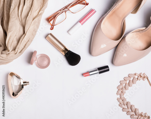Woman's accessories on white table, top view
