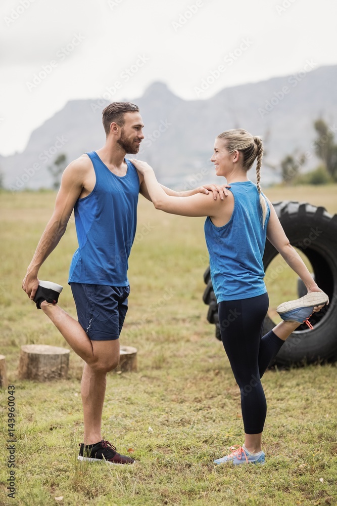 Fototapeta premium Fit people performing stretching exercise