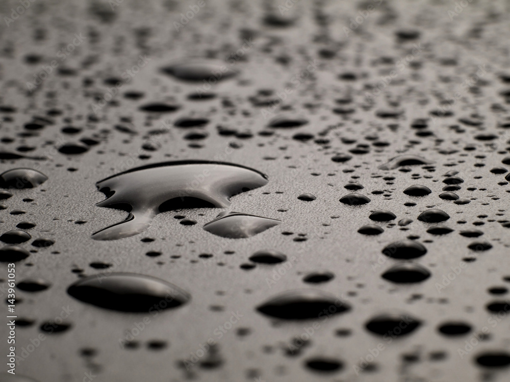 water drops on black surface, macro, shallow depth of field water drops on black surface, macro, shallow depth of field