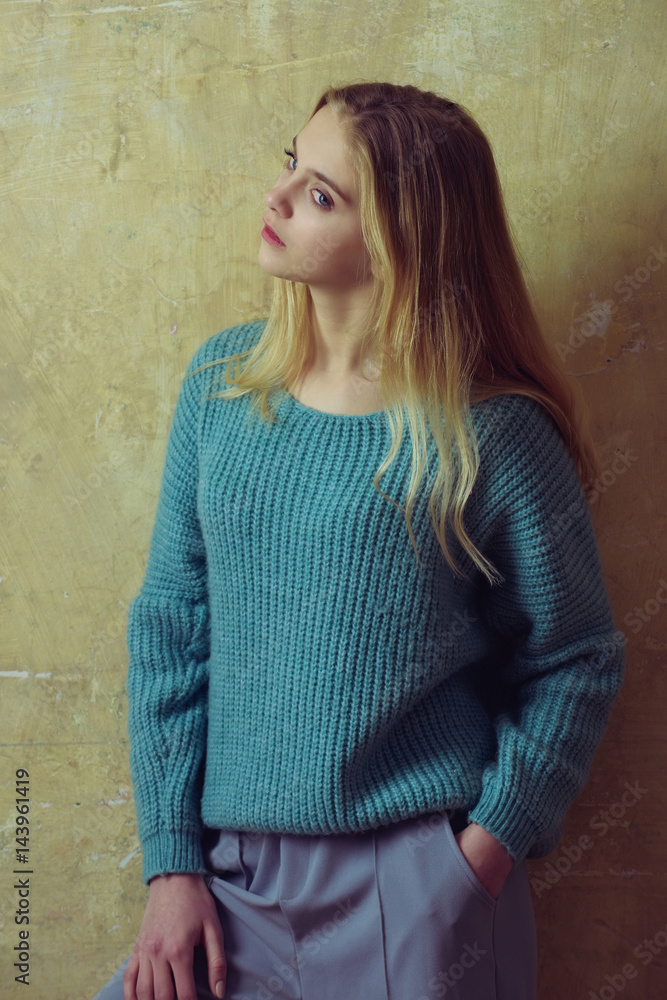 Pretty young girl with blond hair in fashionable sweater, culottes Pretty young girl with blond hair in fashionable sweater, culottes