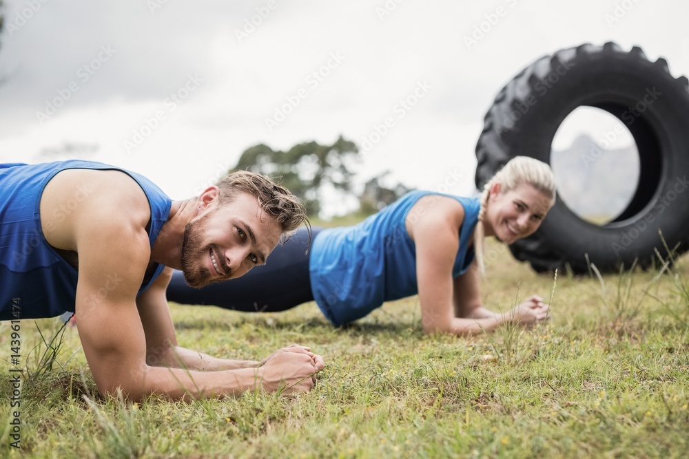 Fit people performing pushup exercise Fit people performing pushup exercise