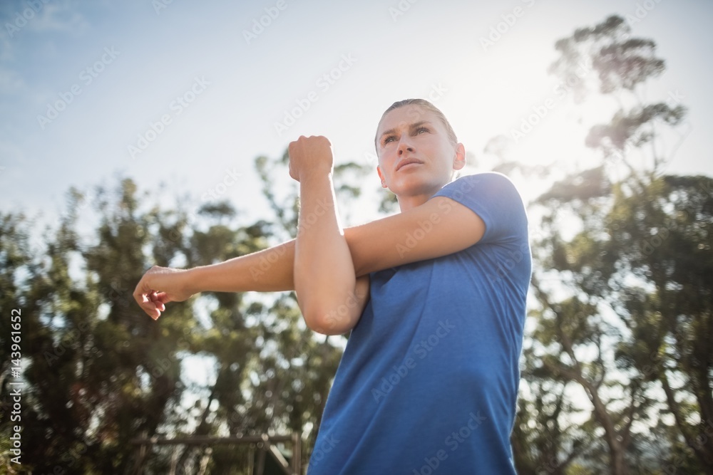 Fit woman performing stretching exercise Fit woman performing stretching exercise