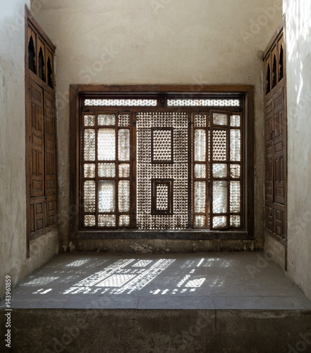 Interleaved wooden window (Mashrabiya) with built-in couch, Medieval Cairo, Egypt photo