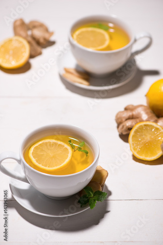 Healthy ginger tea ingredients on a wooden table