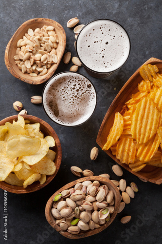 Lager beer and snacks on stone table