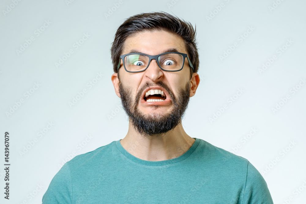 Angry and furious male on a gray background Angry and furious male on a gray background