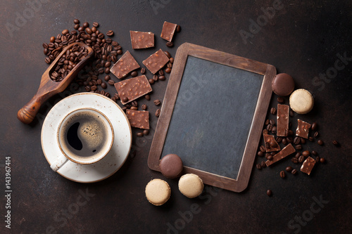 Coffee, chocolate and macaroons on old kitchen table photo