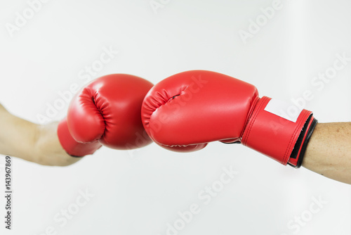 Fighter man punching with red boxing gloves. Boxing practicing. © eggeeggjiew