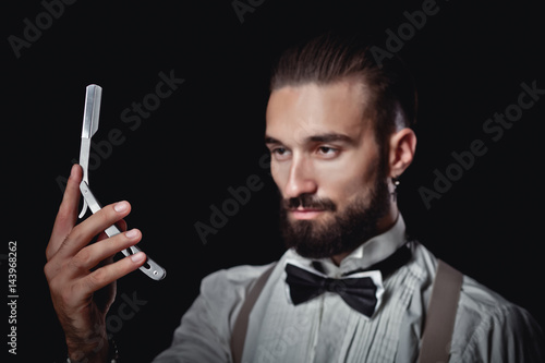 Portrait of handsome man posing for photographer in studio, Dangerous razor, © aemstock