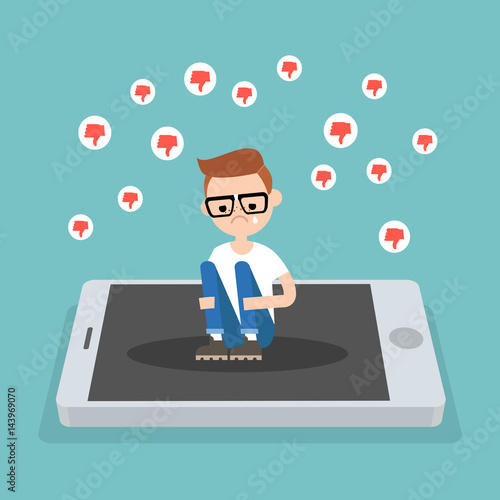 Upset crying nerd sitting on the mobile's screen and hugging his knees surrounded by the dislike symbols / editable flat vector illustration, clip art