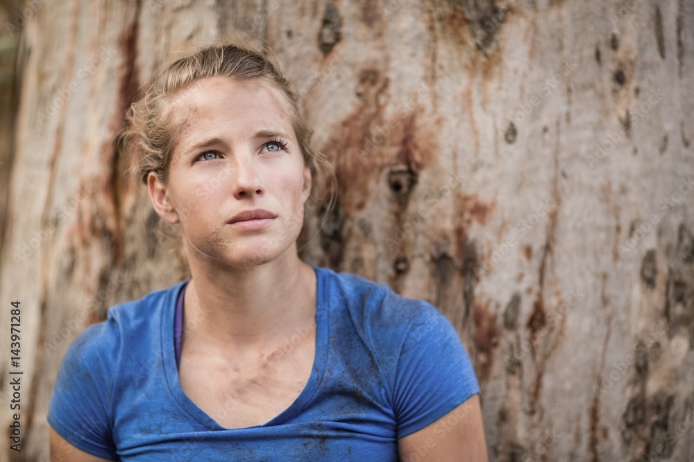 Thoughtful fit woman standing during obstacle course Thoughtful fit woman standing during obstacle course