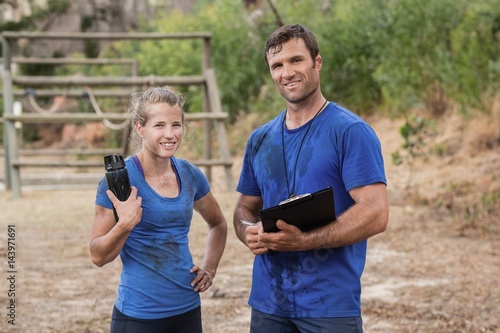 Trainer and woman standing together during obstacle course © WavebreakMediaMicro