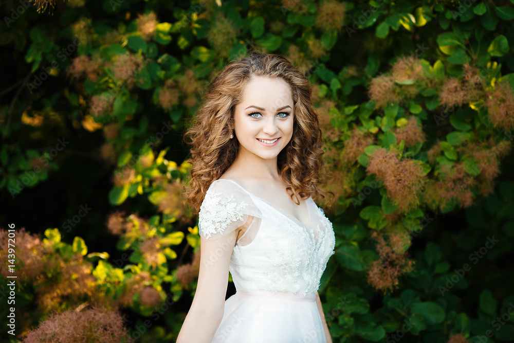Curly haired girl dressed in white gown Curly haired girl dressed in white gown