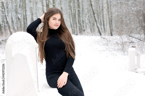 Teenager girl in the snow with fur coat