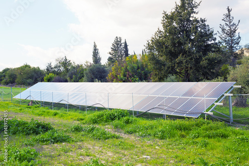 Solar panels placed on a countryside meadow.