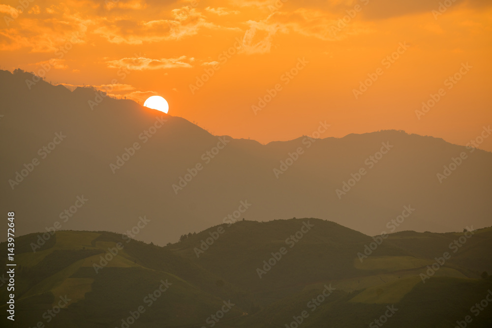 Big Sun and cloudy sunset time at Rice field terraces on the mountain In Mu Cang Chai Yenbai Vietnam.