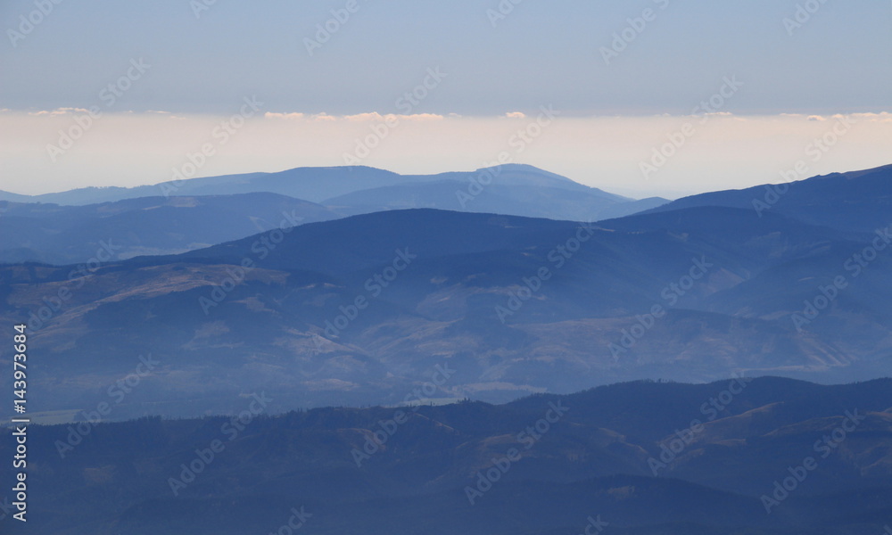 Blue ridges of Low Tatras, Low Tatras National Park, and Slovak Ore Mountains, Slovak Paradise National Park, with Predna Hola and Stolica peaks, from Lomnicky peak, High Tatra, Slovakia, Europe