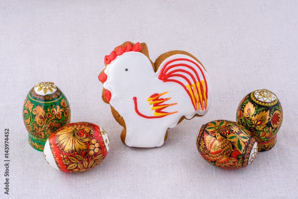 Souvenirs stick cock and eggs easters decorative on a light background of natural linen tablecloths Souvenirs stick cock and eggs easters decorative on a light background of natural linen tablecloths