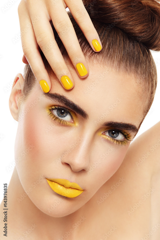 Young beautiful woman with fancy yellow make-up and manicure Young beautiful woman with fancy yellow make-up and manicure