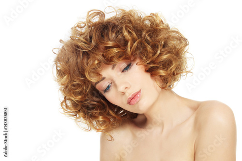 Young beautiful sexy woman with curly hair over white background, copy space