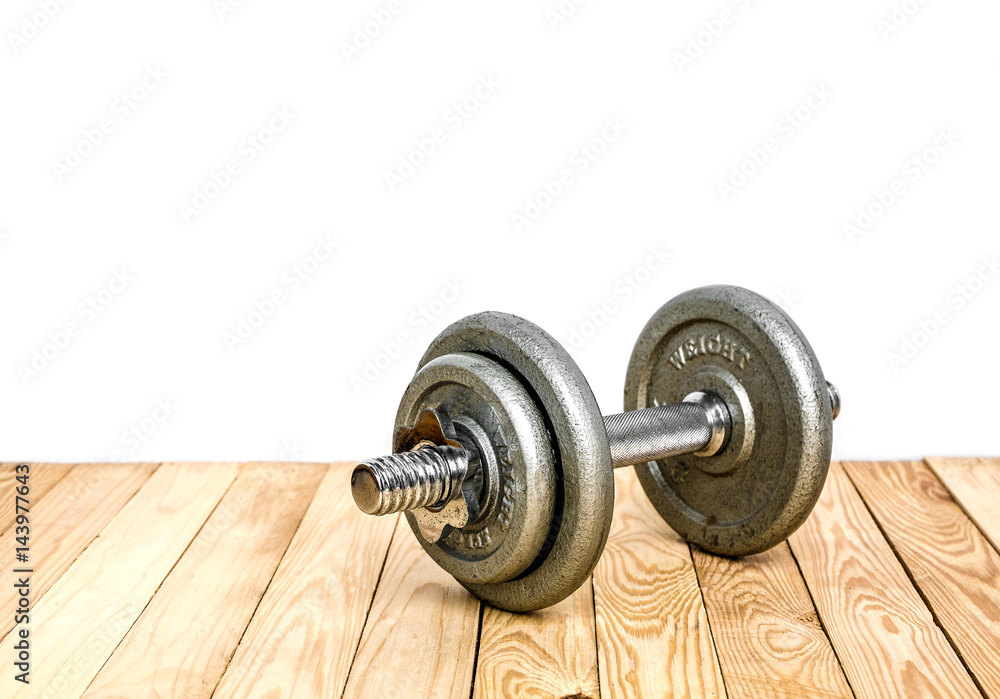 Dumbbells , weight plates on wooden background for bodybuilder. Concept for sport player or workout. gym of accessories for fitness Dumbbells , weight plates on wooden background for bodybuilder. Concept for sport player or workout. gym of accessories for fitness
