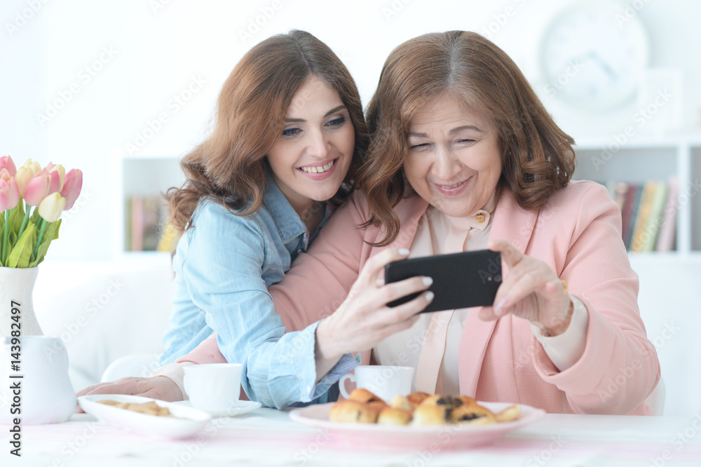 Daughter teaches an elderly mother to use a mobile phone Daughter teaches an elderly mother to use a mobile phone
