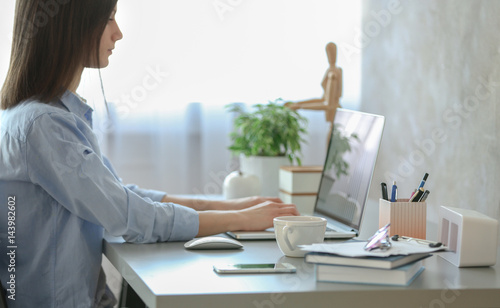 Woman working on laptop at ...