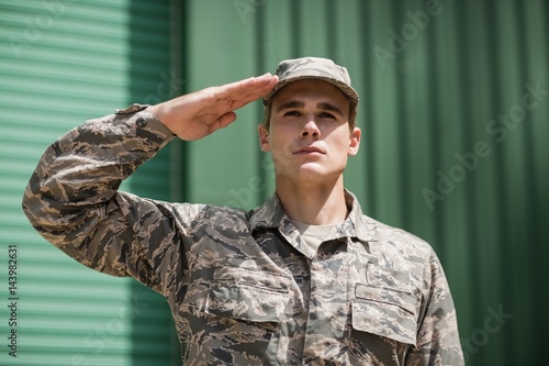 Close-up of military soldier giving salute photo