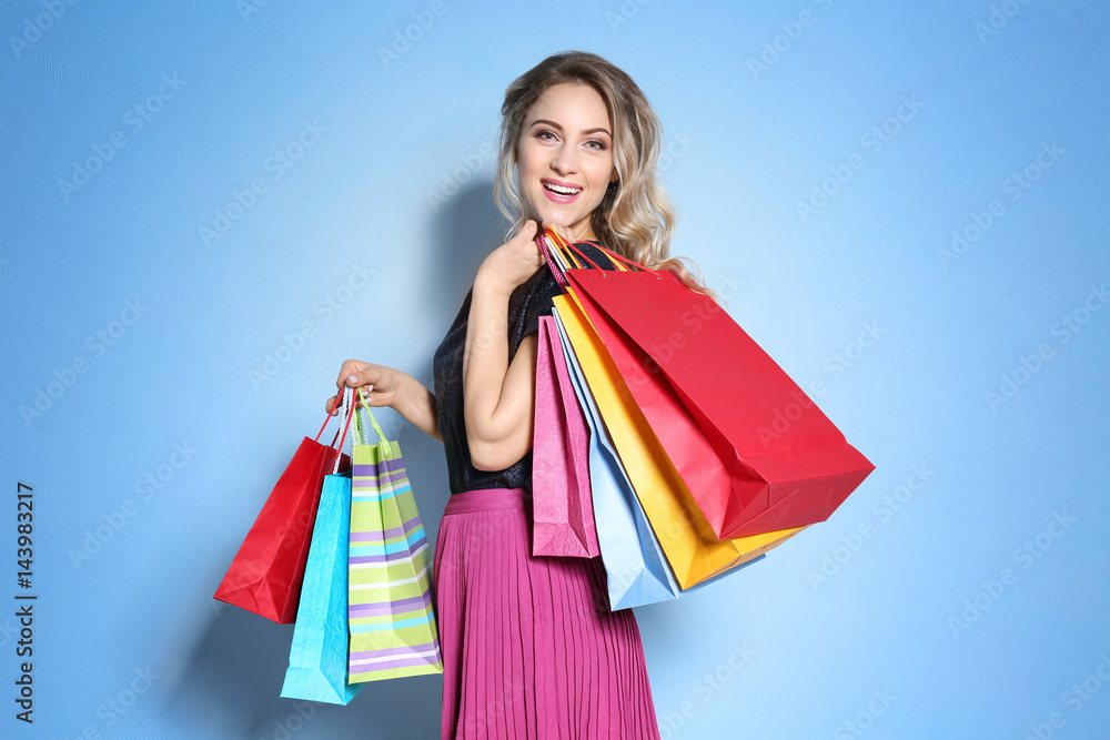 Woman with shopping bags on light background Woman with shopping bags on light background