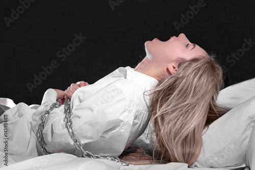 Quadro em tela Girl tied with chain in bed. Sleep paralysis concept