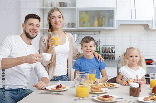Happy family having breakfa...