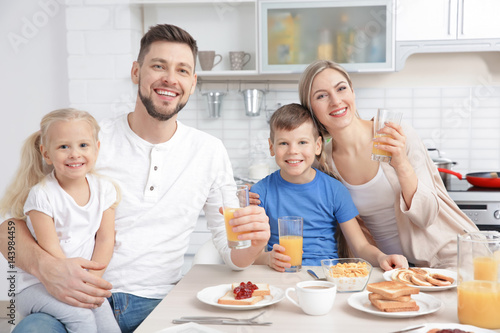 Happy family having breakfa...