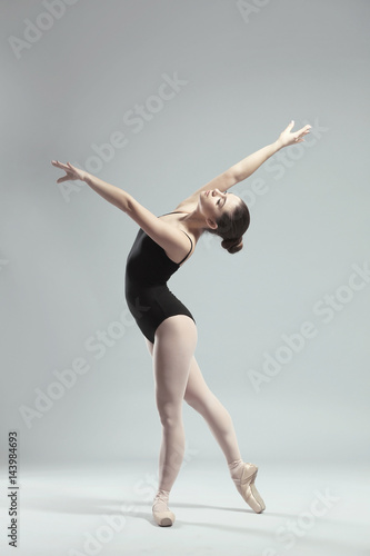 Wallpaper Mural Young beautiful ballerina dancing on light background Torontodigital.ca