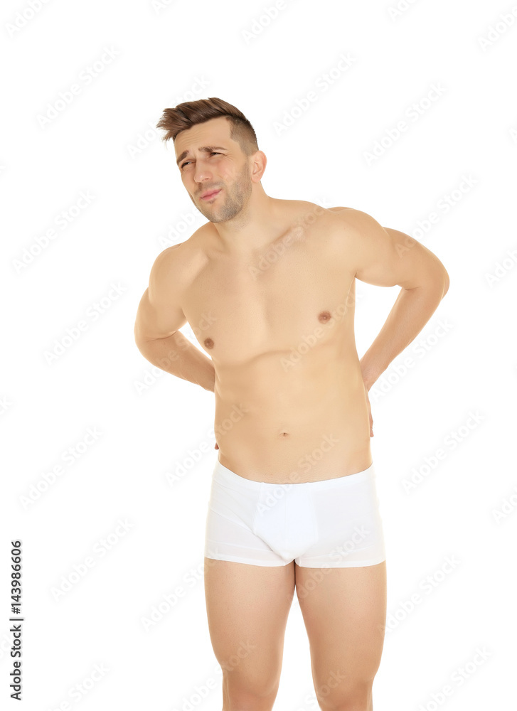 Young man suffering from back pain on white background