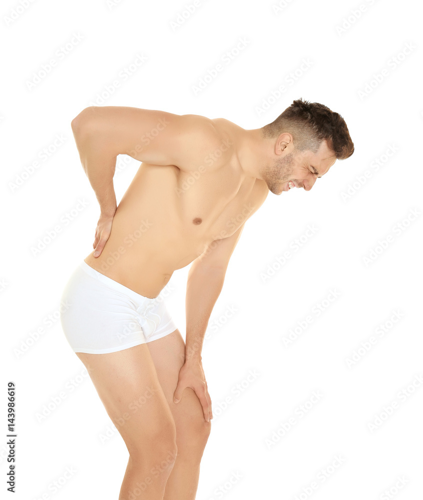 Young man suffering from back pain on white background Young man suffering from back pain on white background