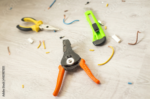 Pliers peeling copper wires, closeup on