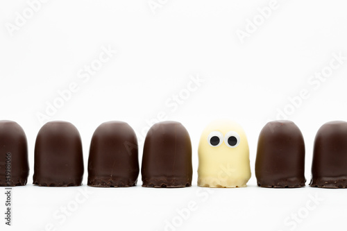 tea cake line - dark and white choco softies with googly eyes on white background photo