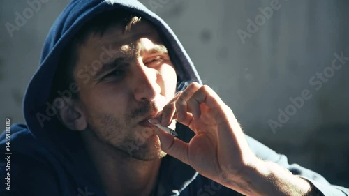 Lonely junkie smoking cigarette in catacombs 4K