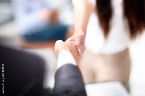 Close up view of business partnership handshake concept.Photo of two businessman handshaking process.Successful deal after great meeting.