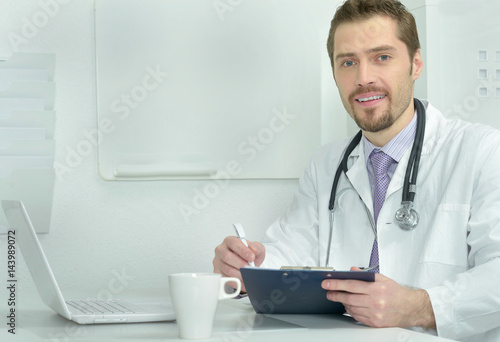 Young doctor with a laptop working