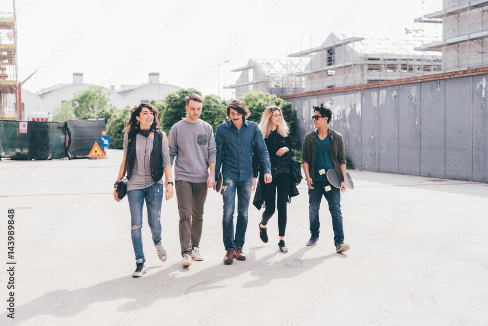 Obraz premium Group of friends multiethnic millennials walking outdoor chatting - having fun, happiness, tofetherness concept